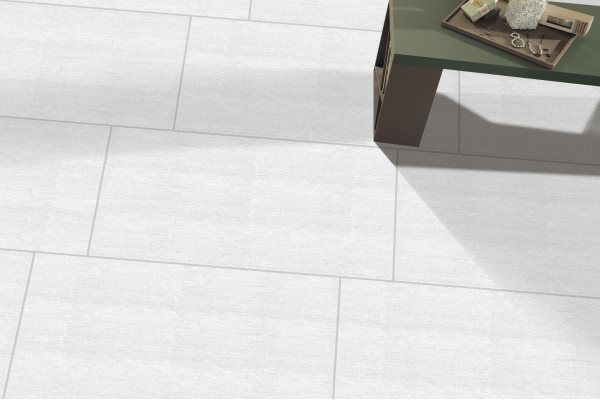 White tile flooring with a small green table casting a shadow on the tiles, holding objects.