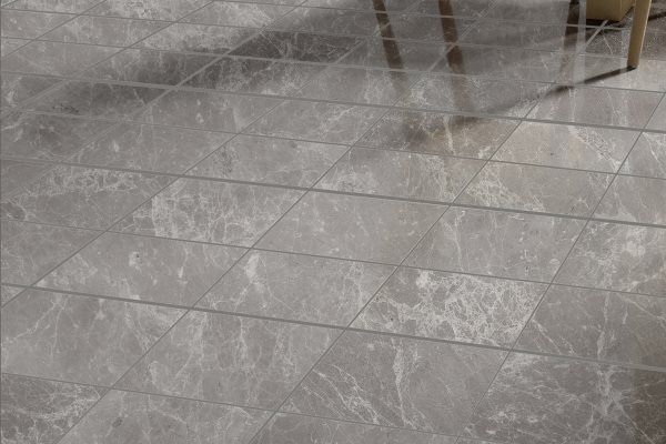 Gray marbled tile floor with a diamond pattern, reflecting light.