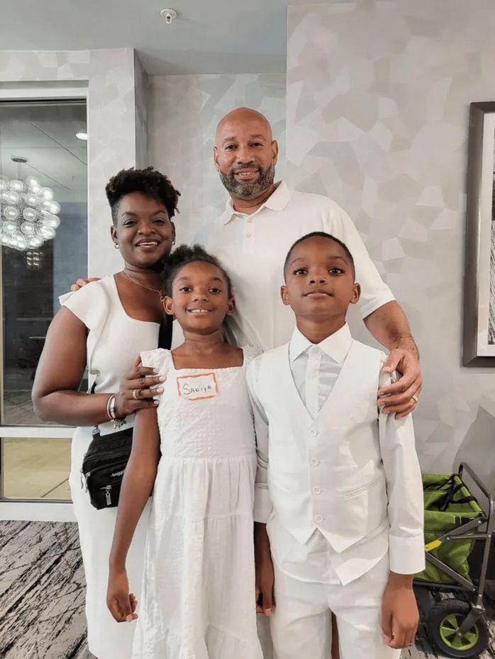 A family is posing for a picture inside their home