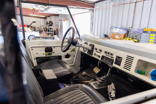 The interior of a jeep is being built in a garage.