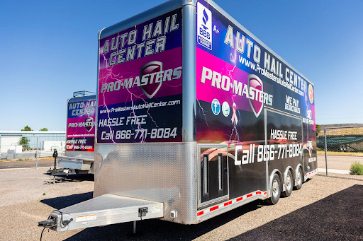 A trailer with a lot of advertisements on it is parked in a parking lot.