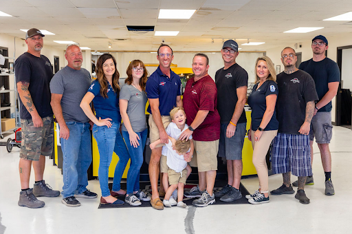 A group of people are posing for a picture in a room.