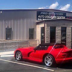 A red sports car is parked in front of a building.