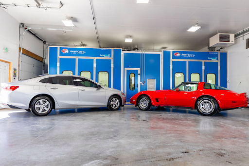 Two cars are parked next to each other in a garage.