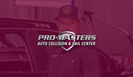 A man wearing a hat is standing in front of a car.