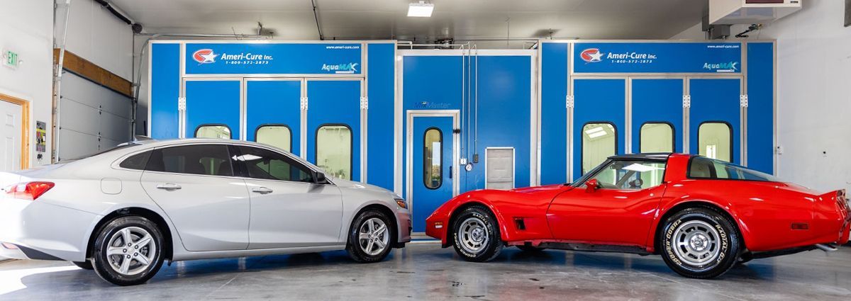 A white car is parked in a garage next to a yellow table.
