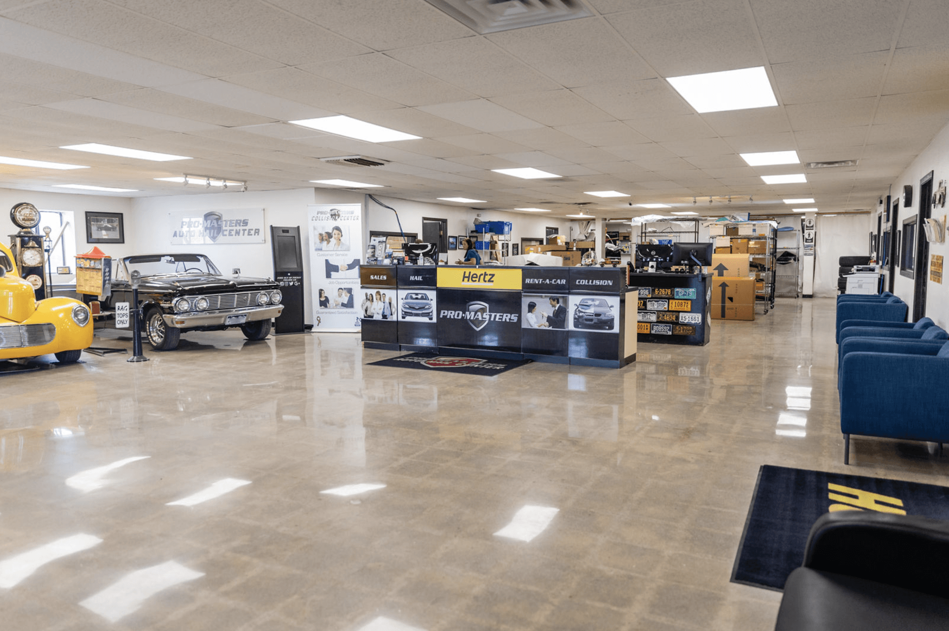 A large room with a lot of furniture and a car in the background.