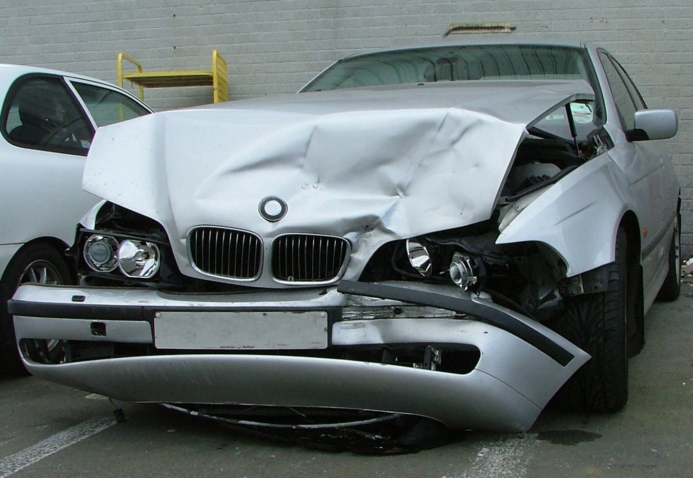 A silver bmw has been damaged in a car accident
