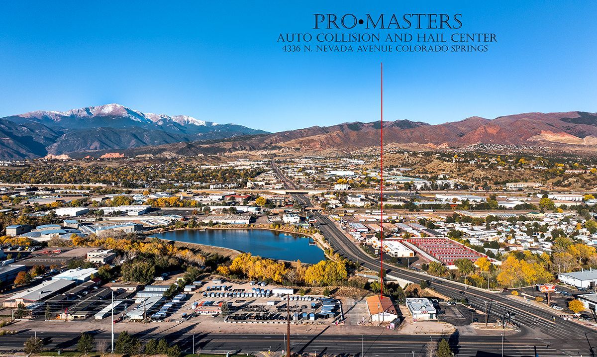 Aerial view of a town with a lake and mountains, a building labeled 