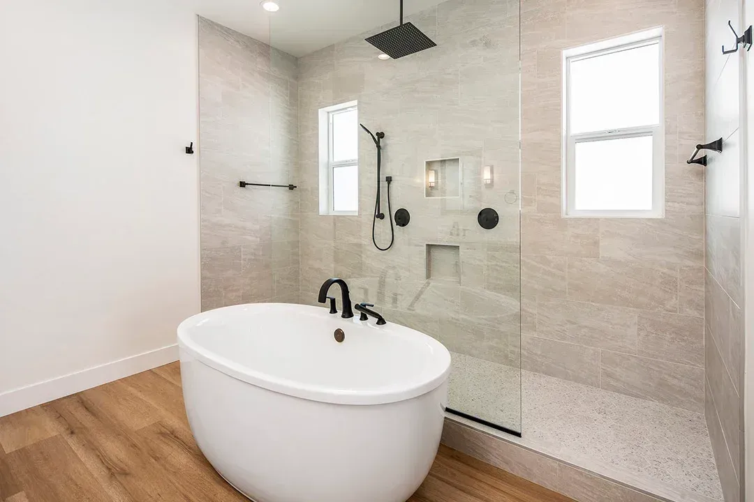 A bathroom with a bathtub and a walk in shower.