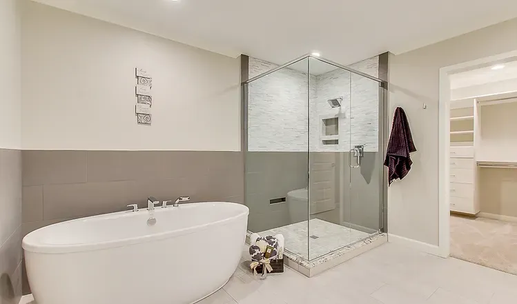 A bathroom with a bathtub and a walk in shower.