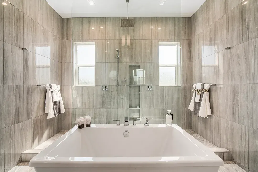 A bathroom with a large tub and a walk in shower.