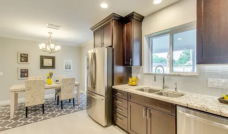 A kitchen with stainless steel appliances and granite counter tops.