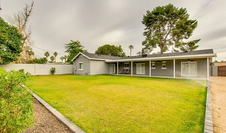 A house with a large lawn in front of it