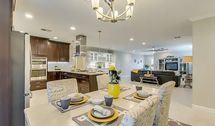 A dining room table with plates and cups on it in a house.