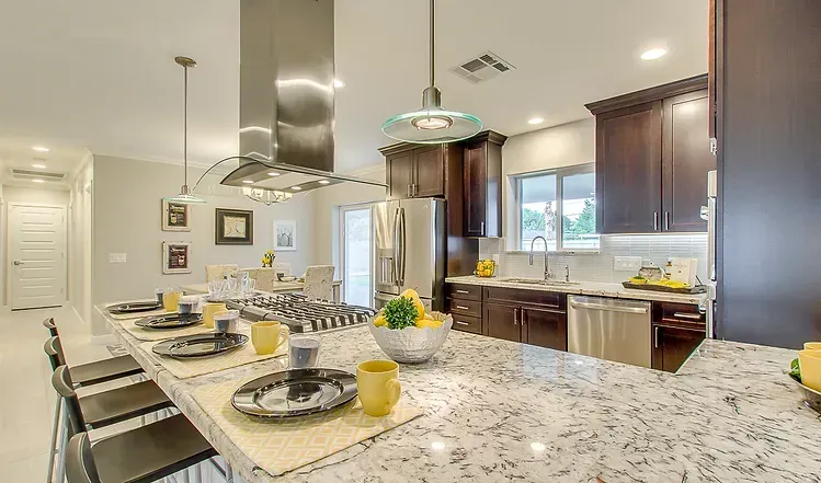 A kitchen with granite counter tops and stainless steel appliances.