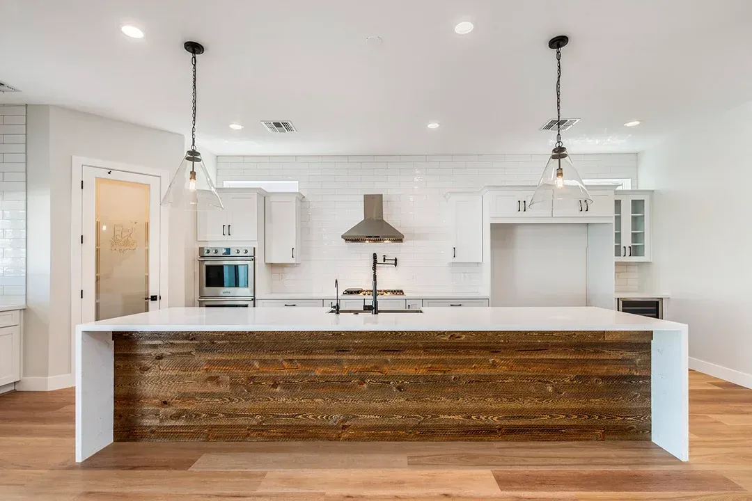 A kitchen with a large island in the middle of the room.