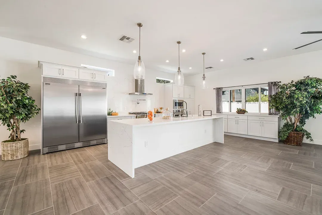 A large kitchen with a large island and stainless steel appliances.