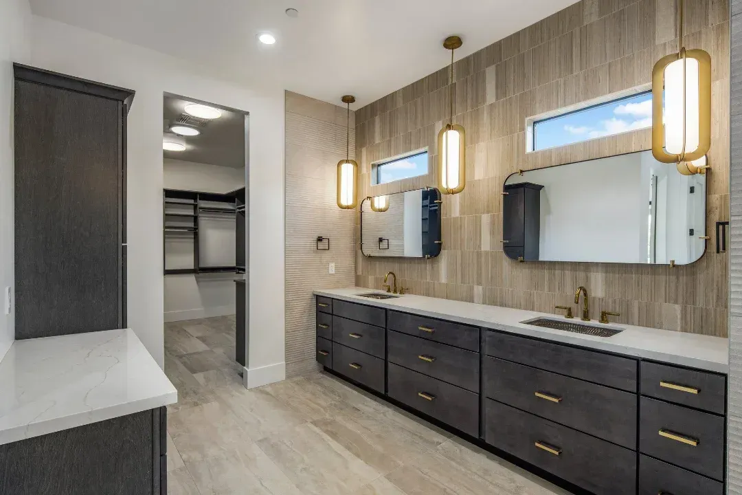 A bathroom with two sinks and two mirrors.