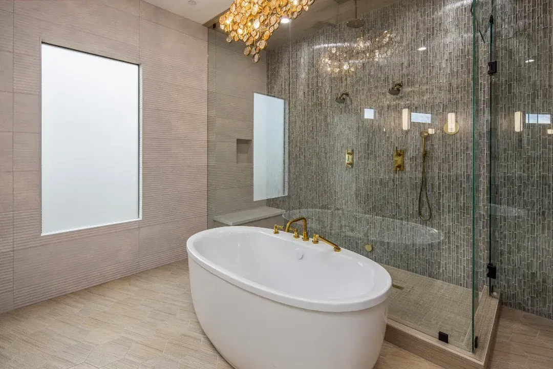 A bathroom with a bathtub and a walk in shower.