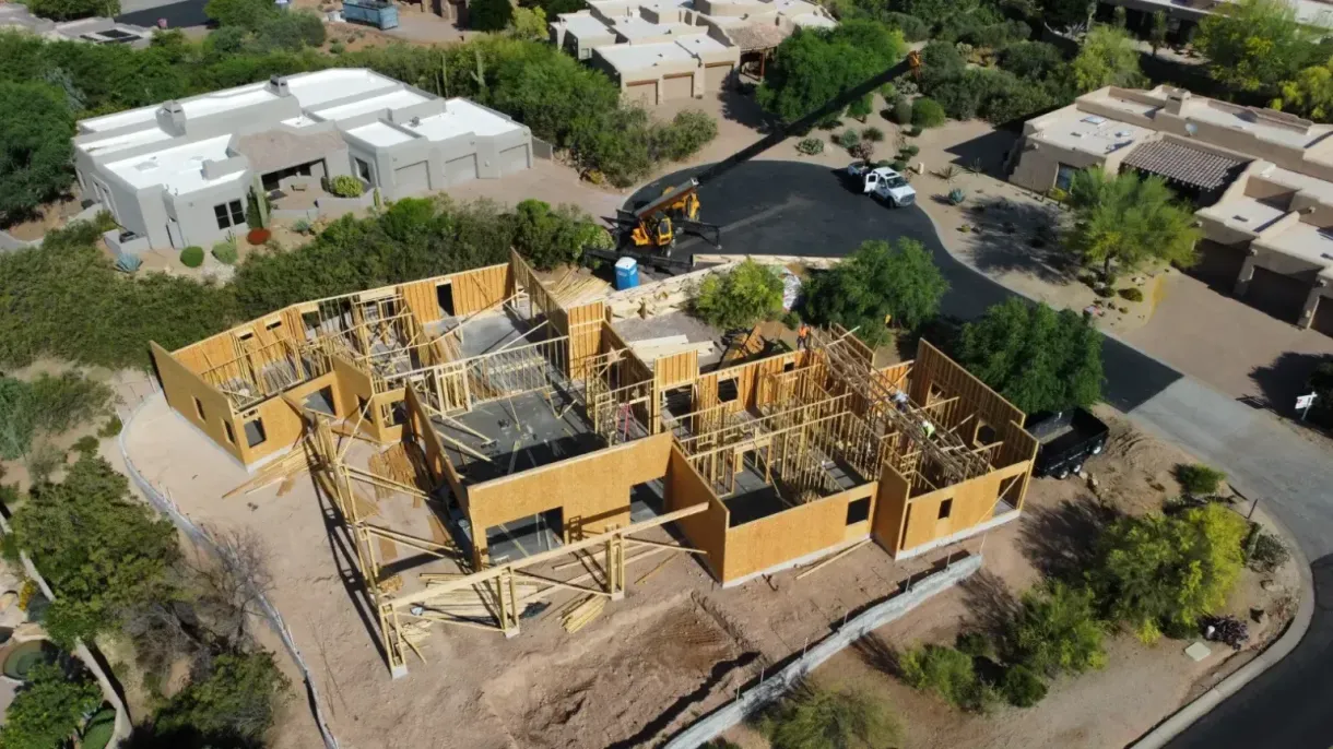 An aerial view of a house under construction in a residential area.