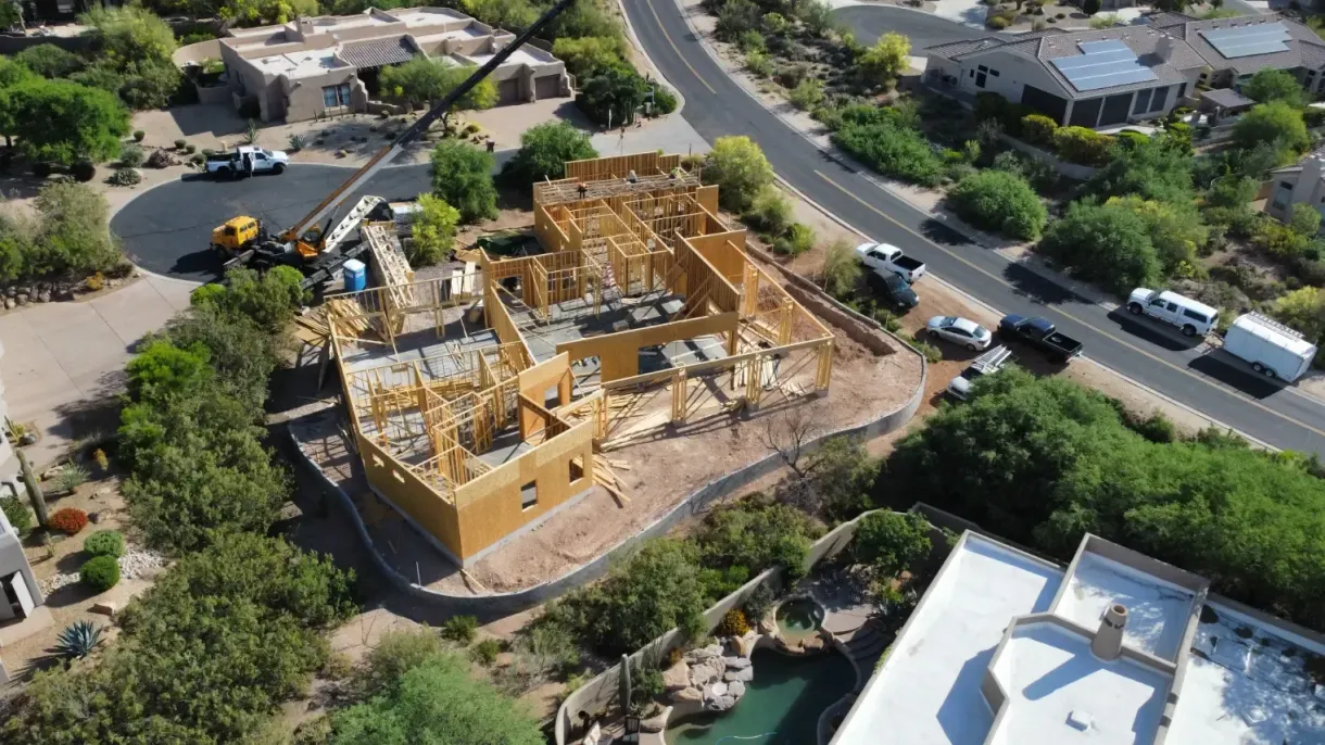 An aerial view of a house under construction in a residential area