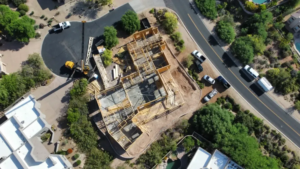 An aerial view of a building under construction in a residential area.