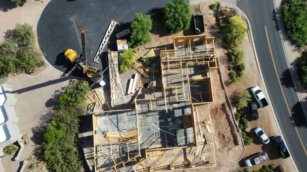 An aerial view of a house under construction in a residential area.