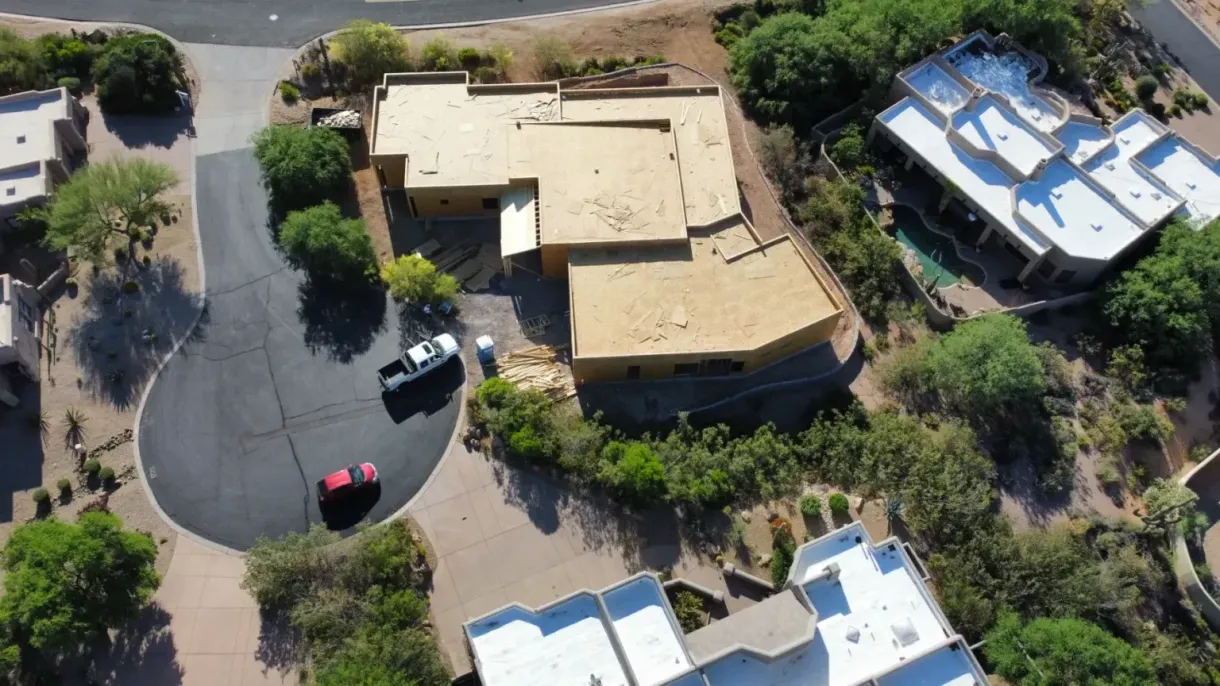 An aerial view of a residential area with houses and trees