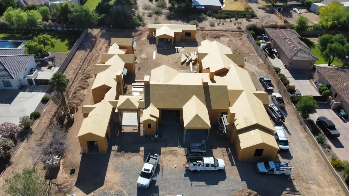 An aerial view of a large house under construction