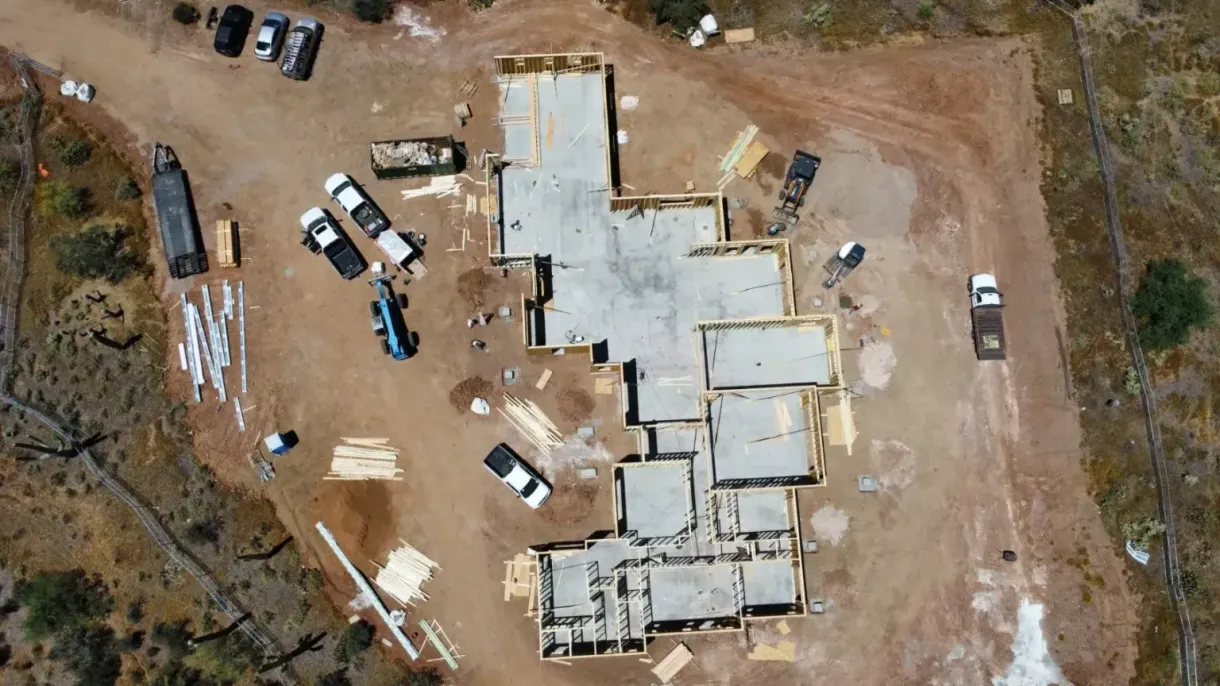 An aerial view of a house under construction in the desert.