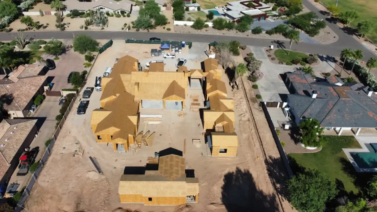 An aerial view of a house under construction in a residential area