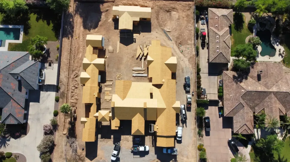 An aerial view of a house under construction in a residential area