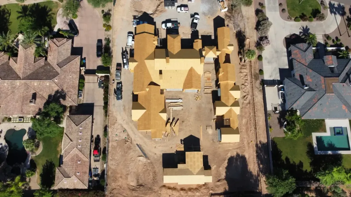 An aerial view of a house under construction in a residential area.