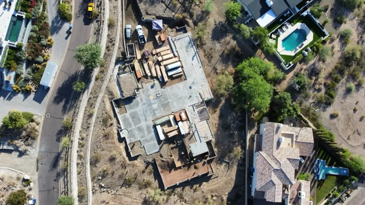 An aerial view of a house under construction in a residential area.