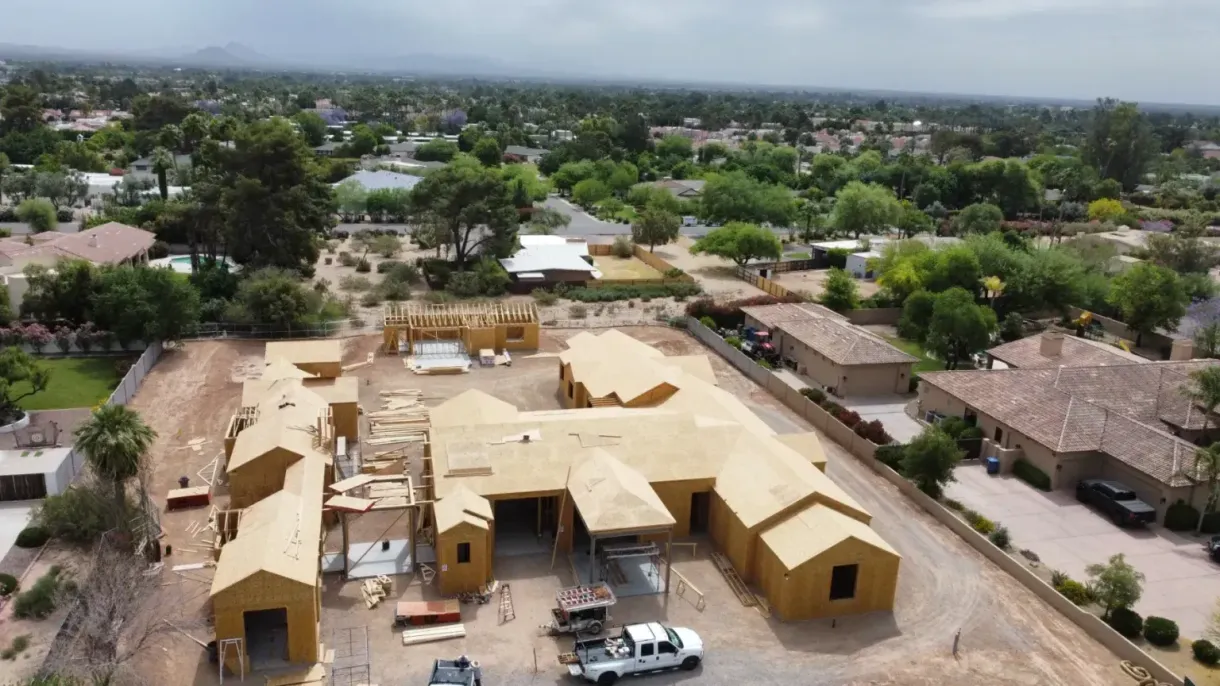 An aerial view of a house under construction in a residential area