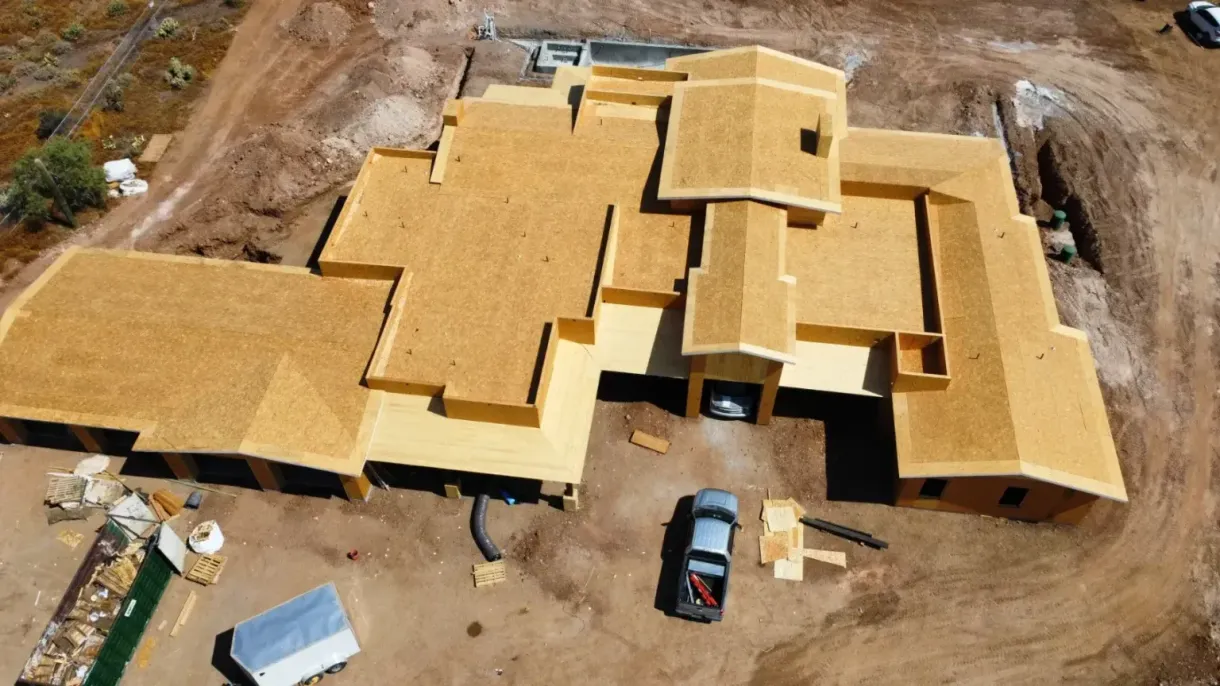 An aerial view of a large house under construction