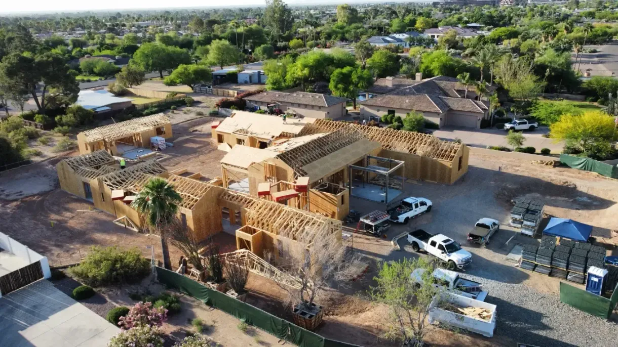 An aerial view of a house under construction in a residential area.