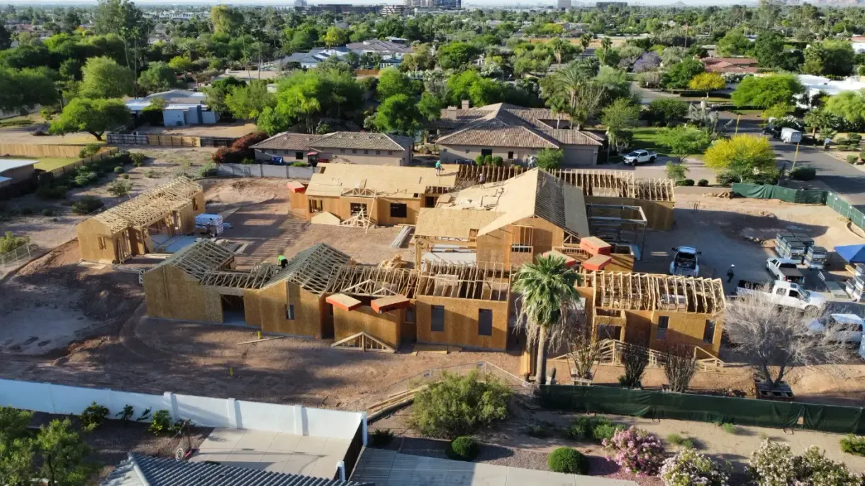 An aerial view of a house under construction in a residential area