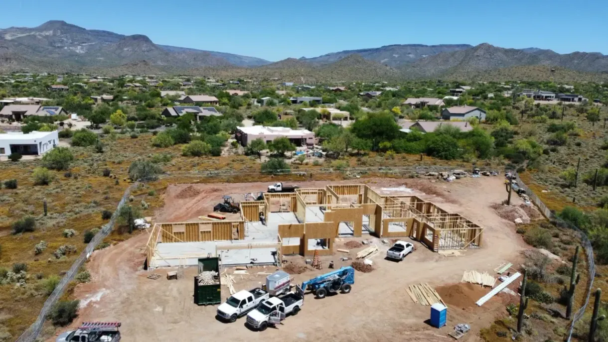 An aerial view of a house under construction in the desert.