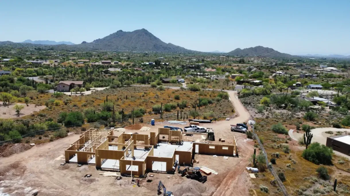 An aerial view of a house under construction in the desert.