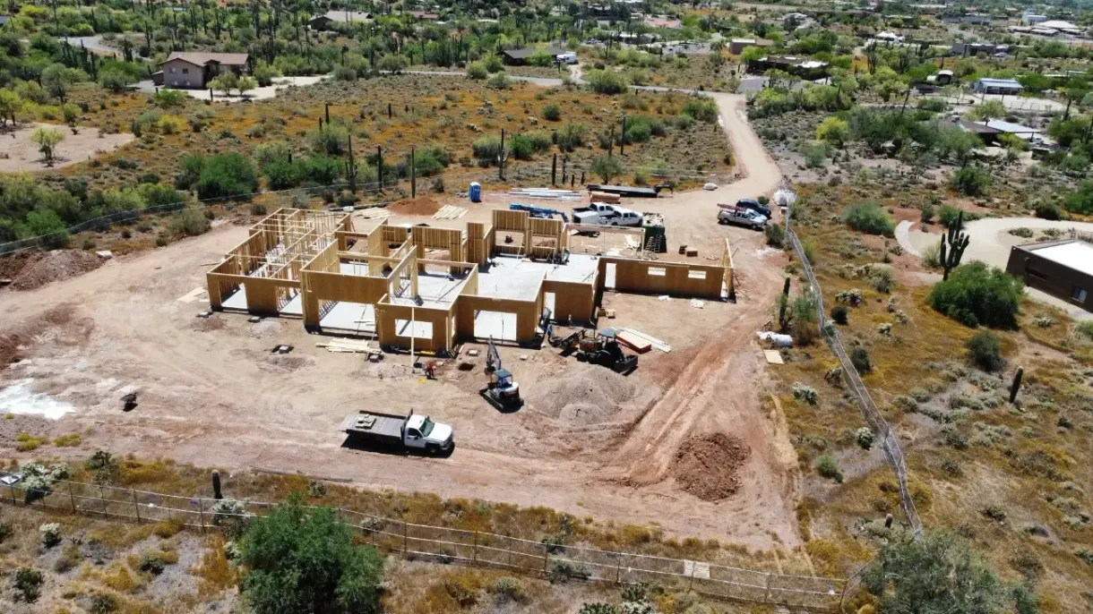 An aerial view of a house under construction in the desert.