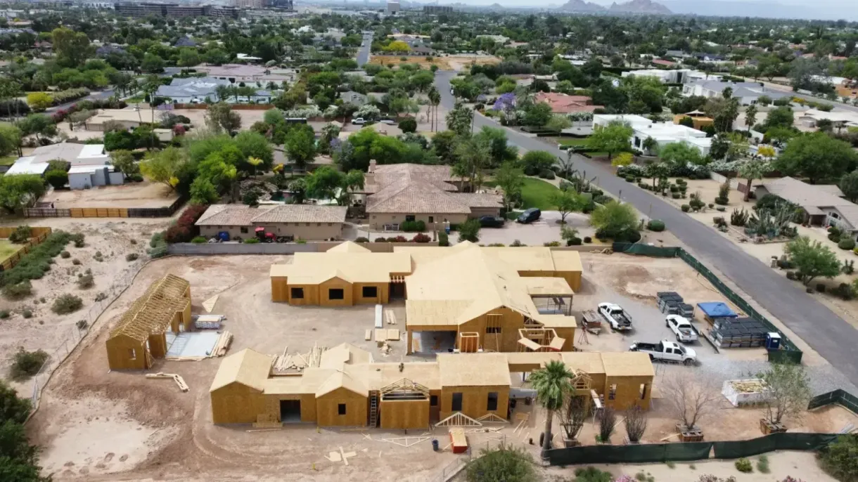 An aerial view of a house under construction in a residential area.