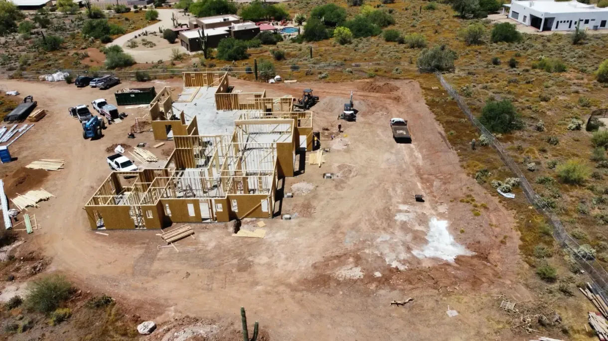 An aerial view of a house under construction in the desert.