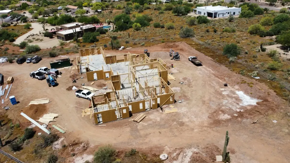 An aerial view of a house under construction in the desert.