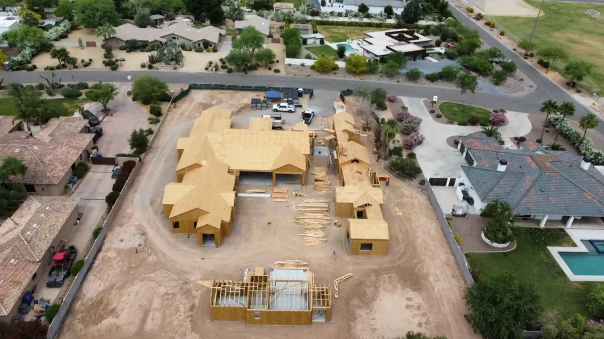 An aerial view of a house under construction in a residential area.