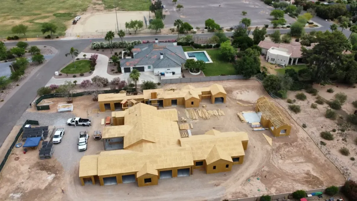 An aerial view of a house under construction in a residential area.