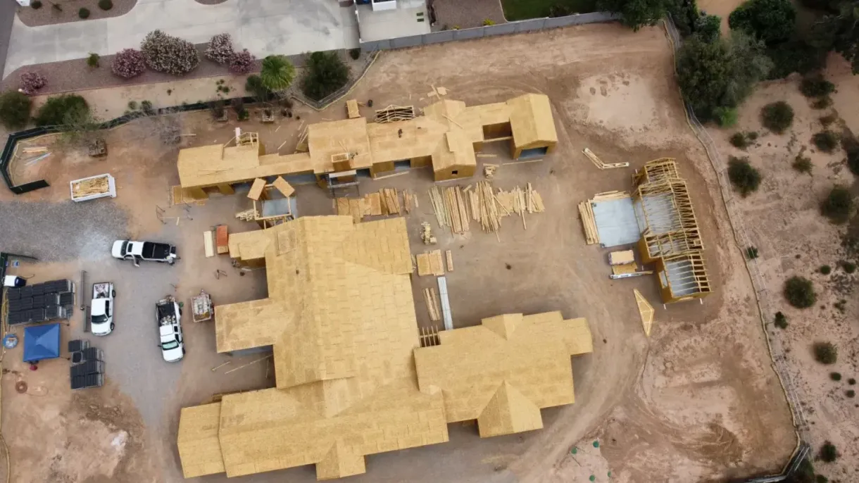 An aerial view of a large house under construction.