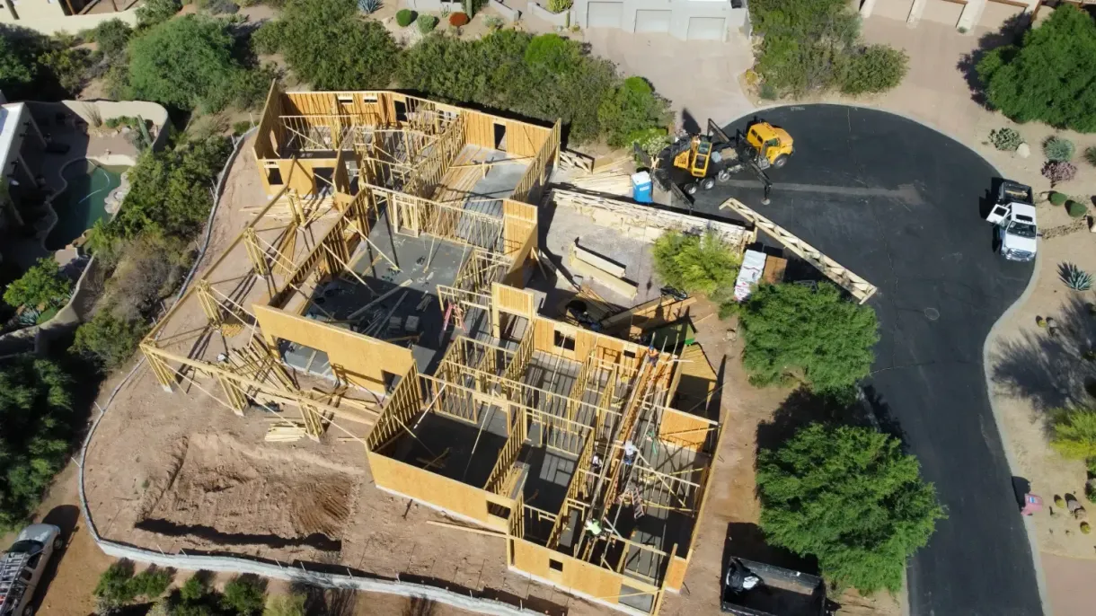 An aerial view of a house under construction in a residential area.