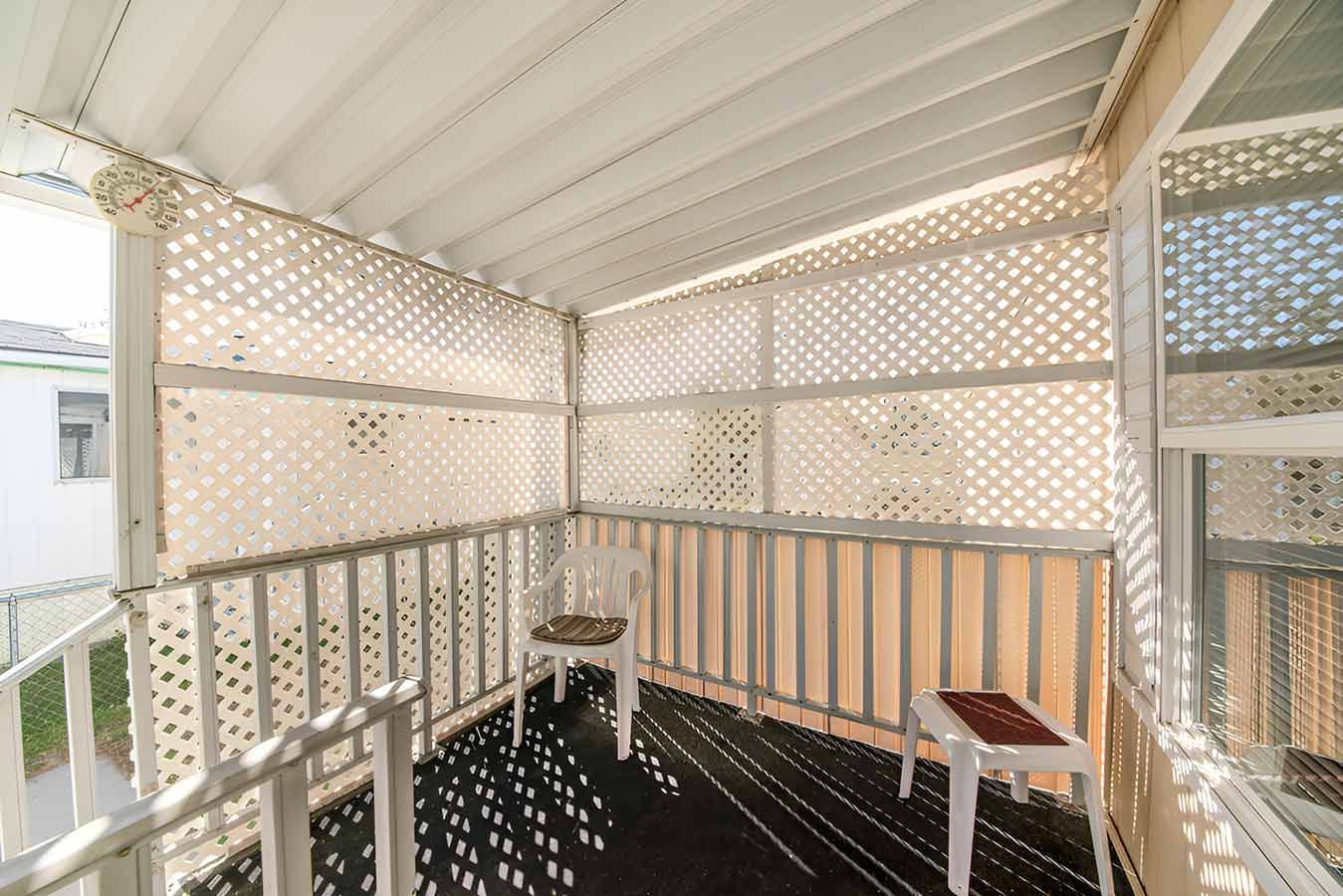 A Porch With a Chair and a Table on It — 2 Deadly Timber & Lattice in Garbutt, QLD